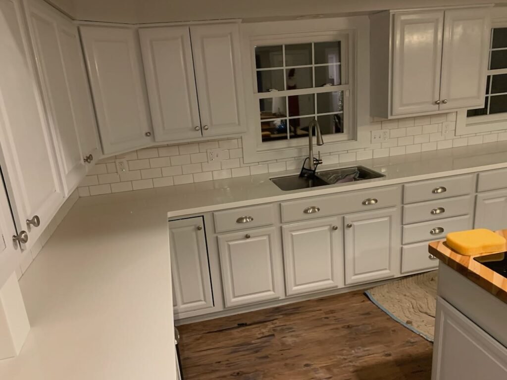 White Subway tile backsplash installation with white solid surface countertops
