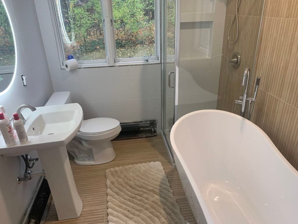 Bathroom Remodel By Mr.Countertops with floor to sealing slate tile, glass shower, modern lighting, and bathtub