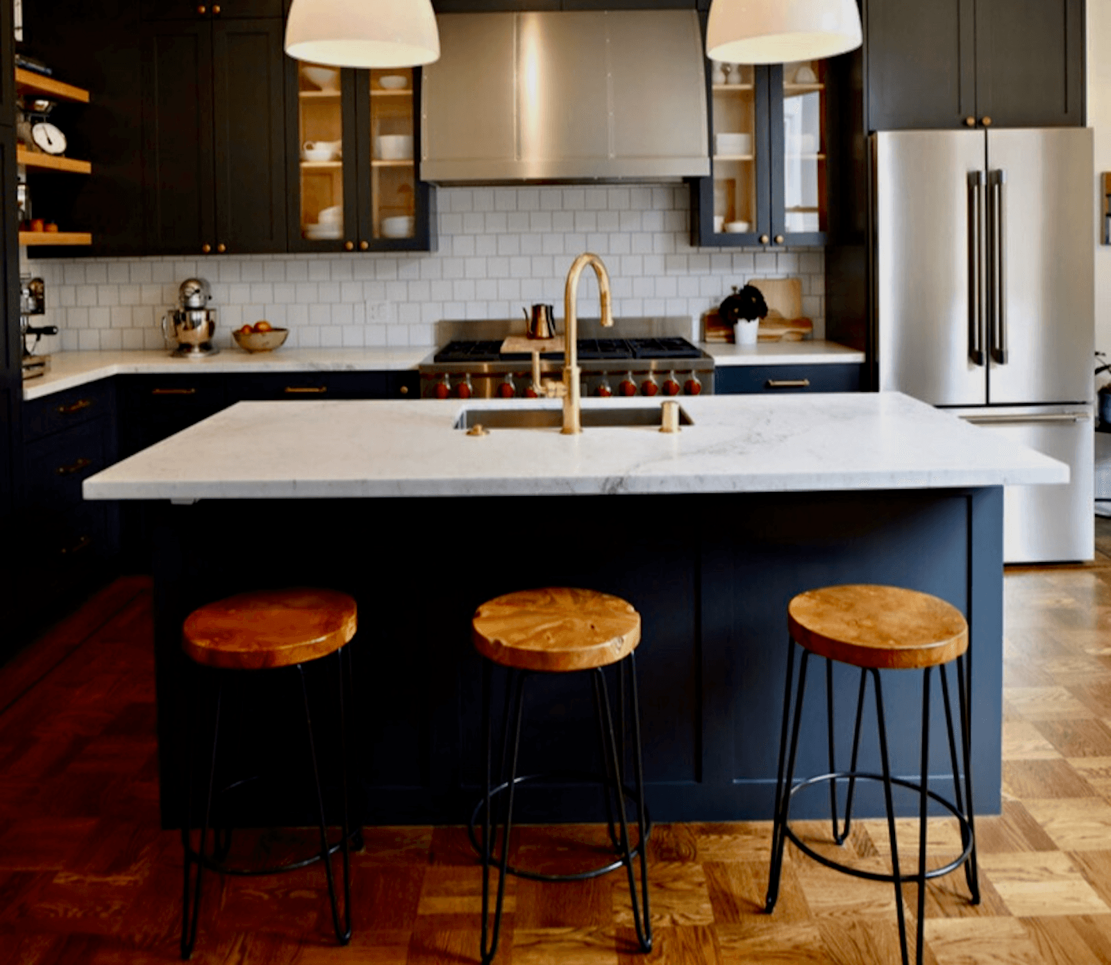Kitchen Remodel with White Countertops and Navy Cabinets with Modern Lighting fixtures in Northeast Ohio Kitchen