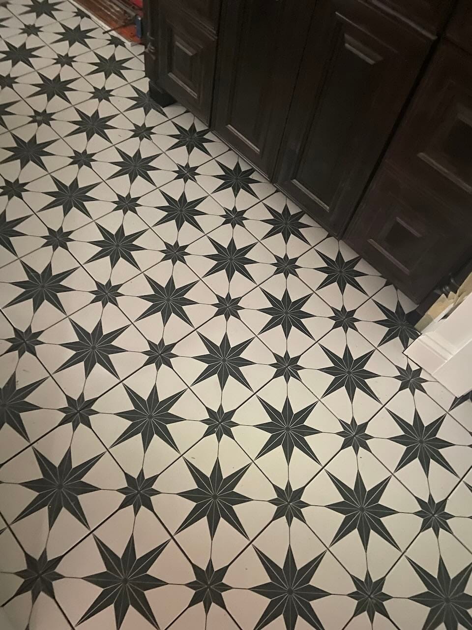 Green and white star pattern tile flooring installation