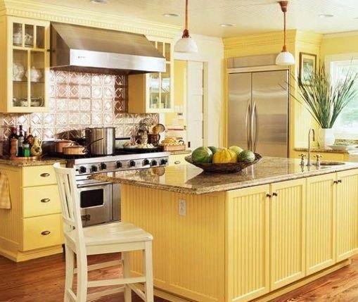 Yellow kitchen cabinets and tile backsplash with custom countertops in Northeast Ohio