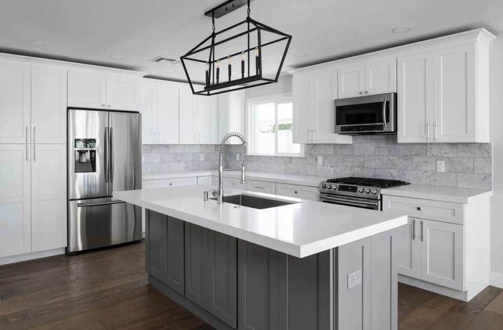 Modern Kitchen Remodel with white solid surface countertops, gray cabinets and white tile in a Northeast Ohio Home