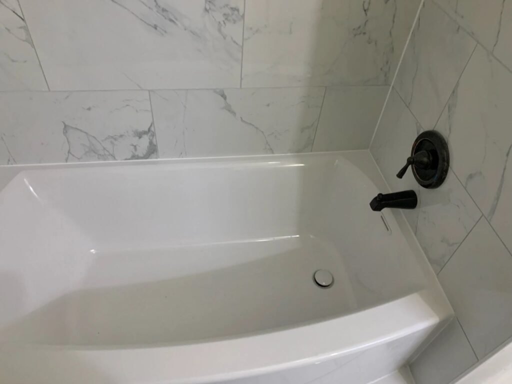 💥After Bathroom Renovation Photo featuring new bathtub & shower tile installation