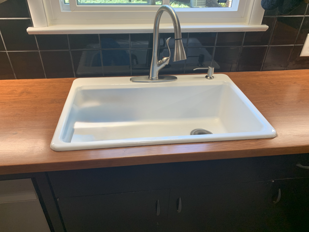 Solid Butcher Block Countertops with sink installation by Mr.Countertops in Wooster Ohio with stunning black tile backsplash.