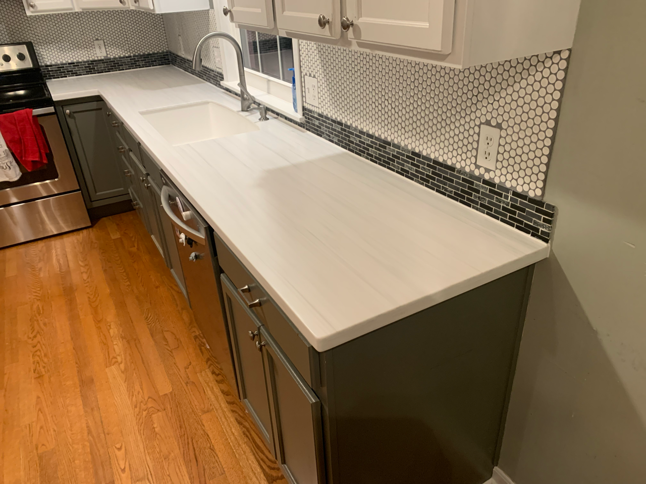 White Solid Surface Countertops with Mosaic tile backsplash in Copley Ohio.