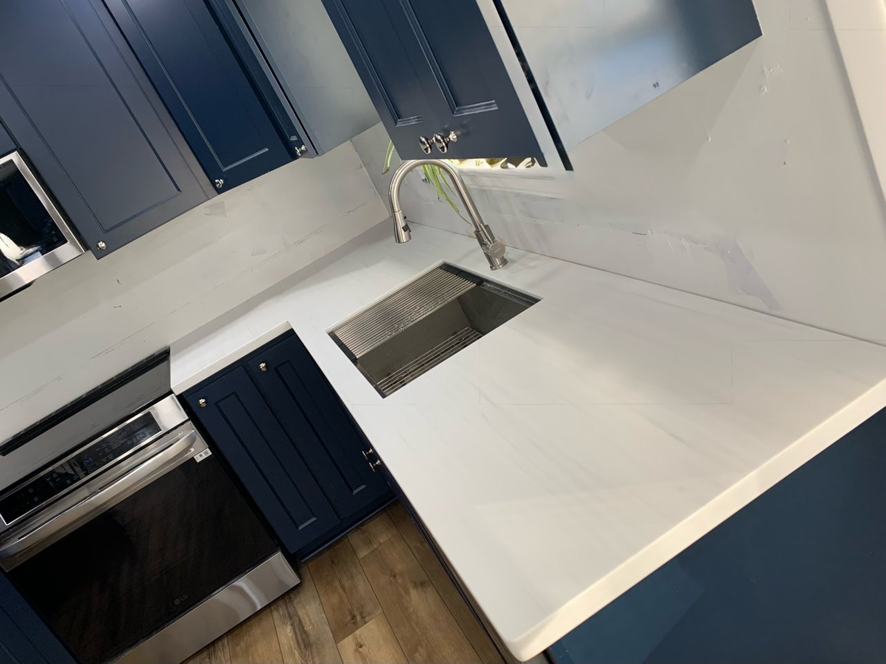 White Countertops with navy cabinets in Northeast Ohio Kitchen by Mr.Countertops in Wadsworth, OH