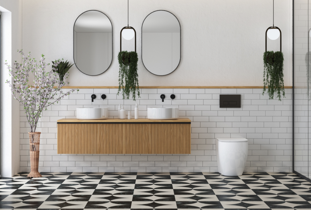Luxury bathroom renovation with intricate black and white patterned tile, wall-mounted floating vanities, double sinks, and modern backlit mirrors.