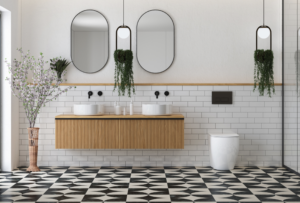 Luxury bathroom renovation with intricate black and white patterned tile, wall-mounted floating vanities, double sinks, and modern backlit mirrors.