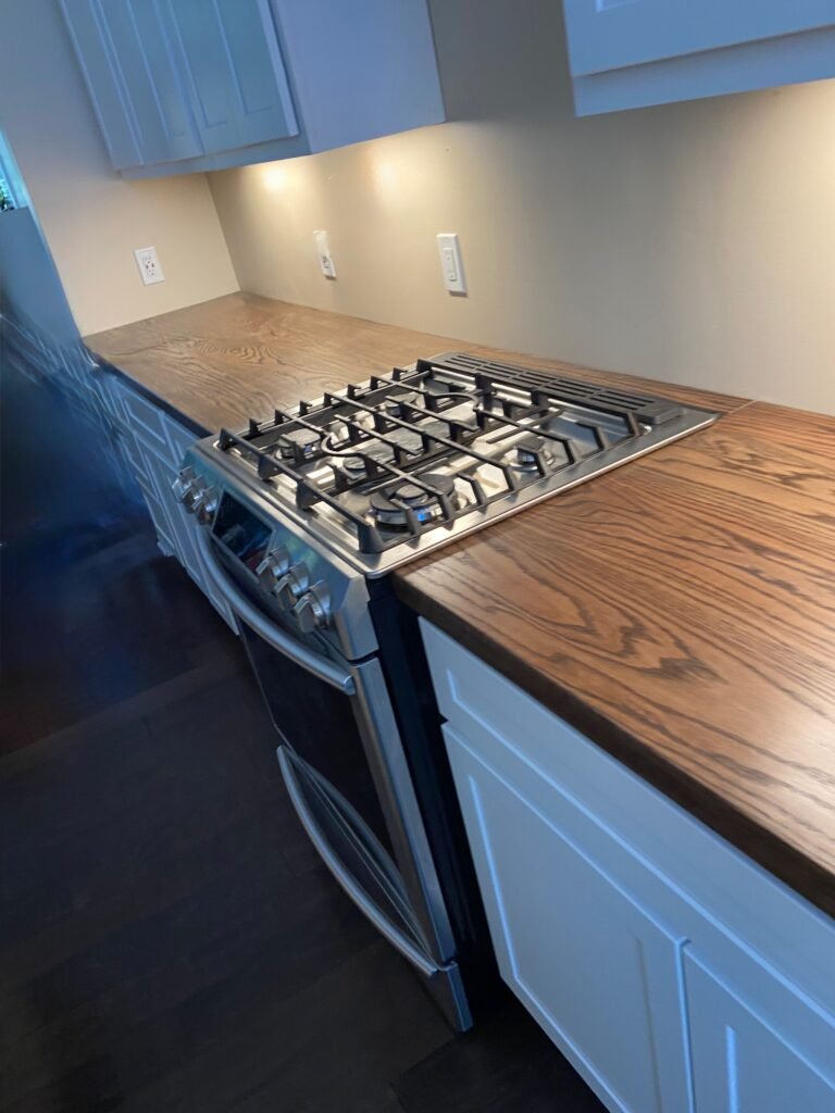Dark black walnut butcher block with a satin waterproof finish.