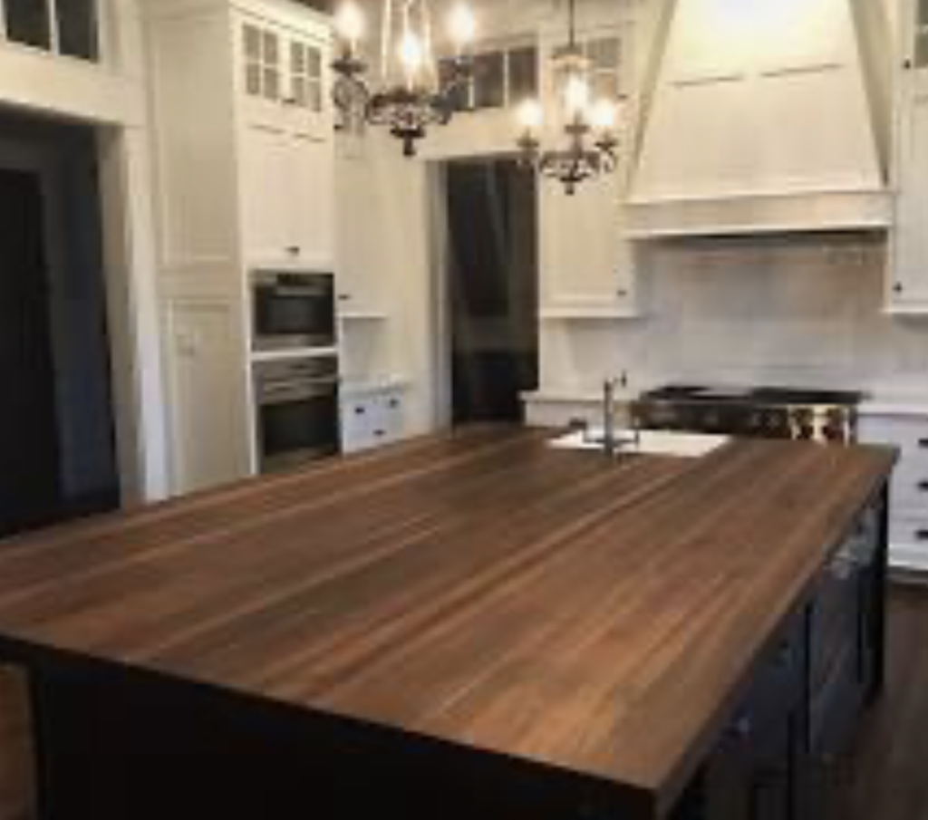 Custom solid walnut kitchen island top with modern seating overhang in a professional kitchen remodel.