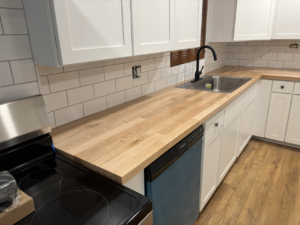 Edge-grain Maple butcher block countertops installed in a custom kitchen with a food-safe oil finish.