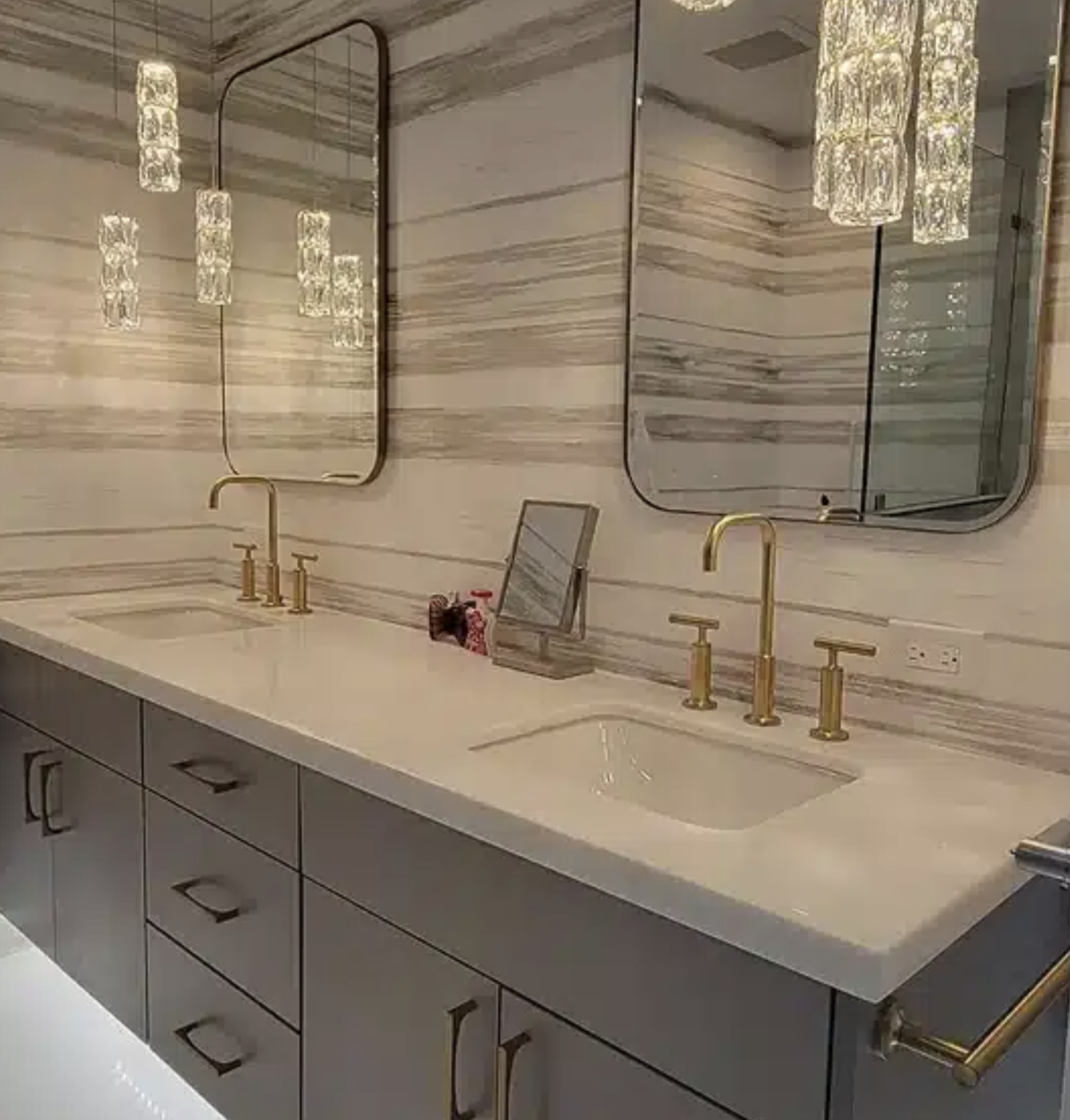 Luxury bathroom remodel with floor to ceiling wall cladding and a seamless double sink vanity.