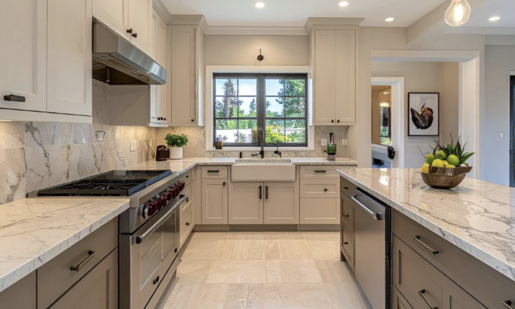 Modern Cleveland kitchen remodel featuring two-tone resurfaced cabinets in mushroom beige and dark wood, stone-look laminate countertops, and a vertical stacked tile backsplash.