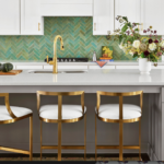 Modern kitchen backsplash featuring emerald green subway tiles installed in a crisp herringbone pattern with contrasting white grout lines. | Mr.Countertops