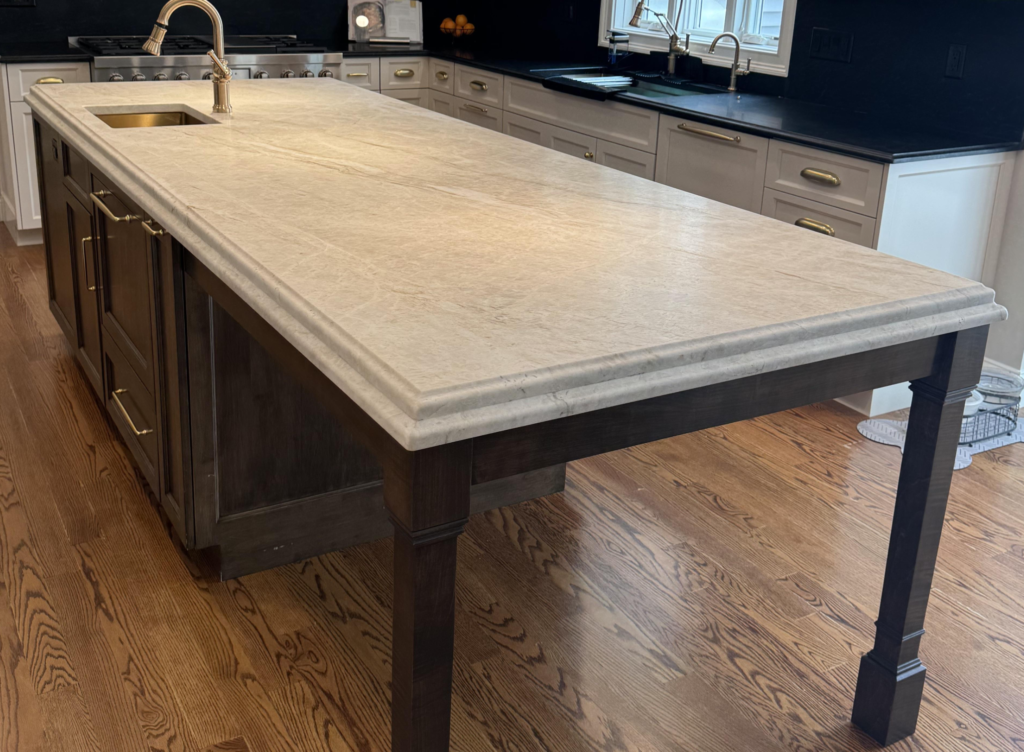 Close-up of custom Corian kitchen island with an intricate ogee S-curve edge profile.