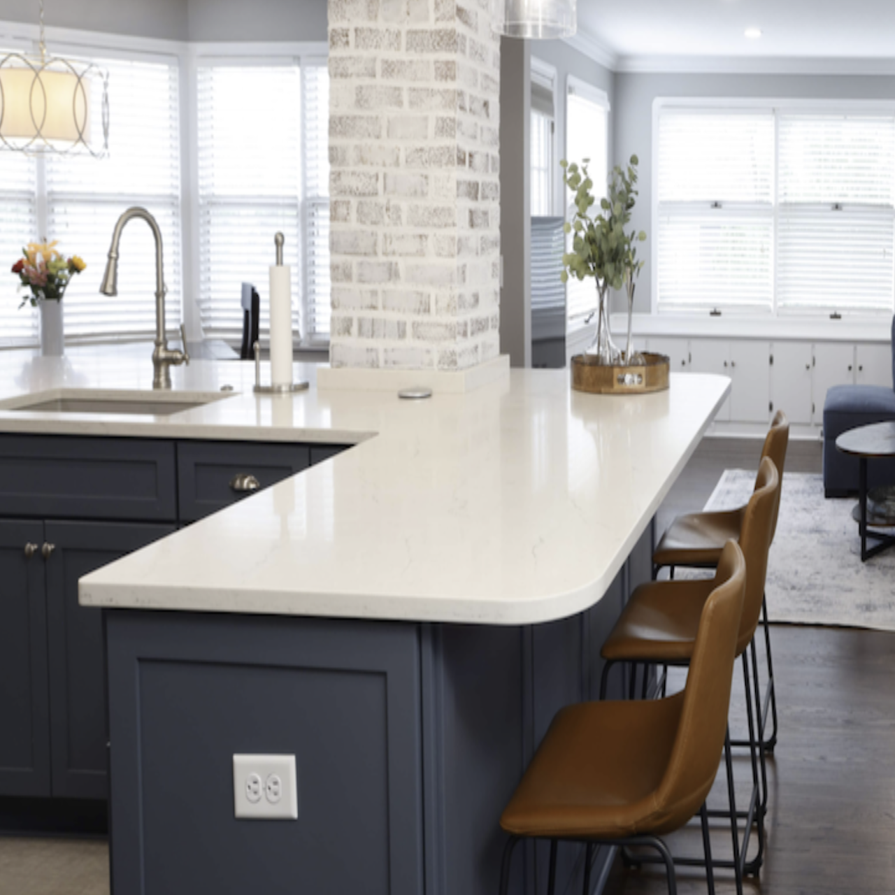 White Solid Surface Countertops with navy cabinets and sit in island | Mr.Countertops