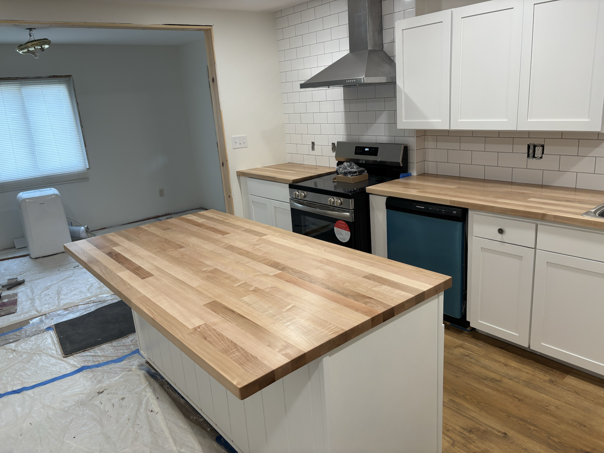 Modern farmhouse white oak kitchen island with seating overhang and matte protective finish.