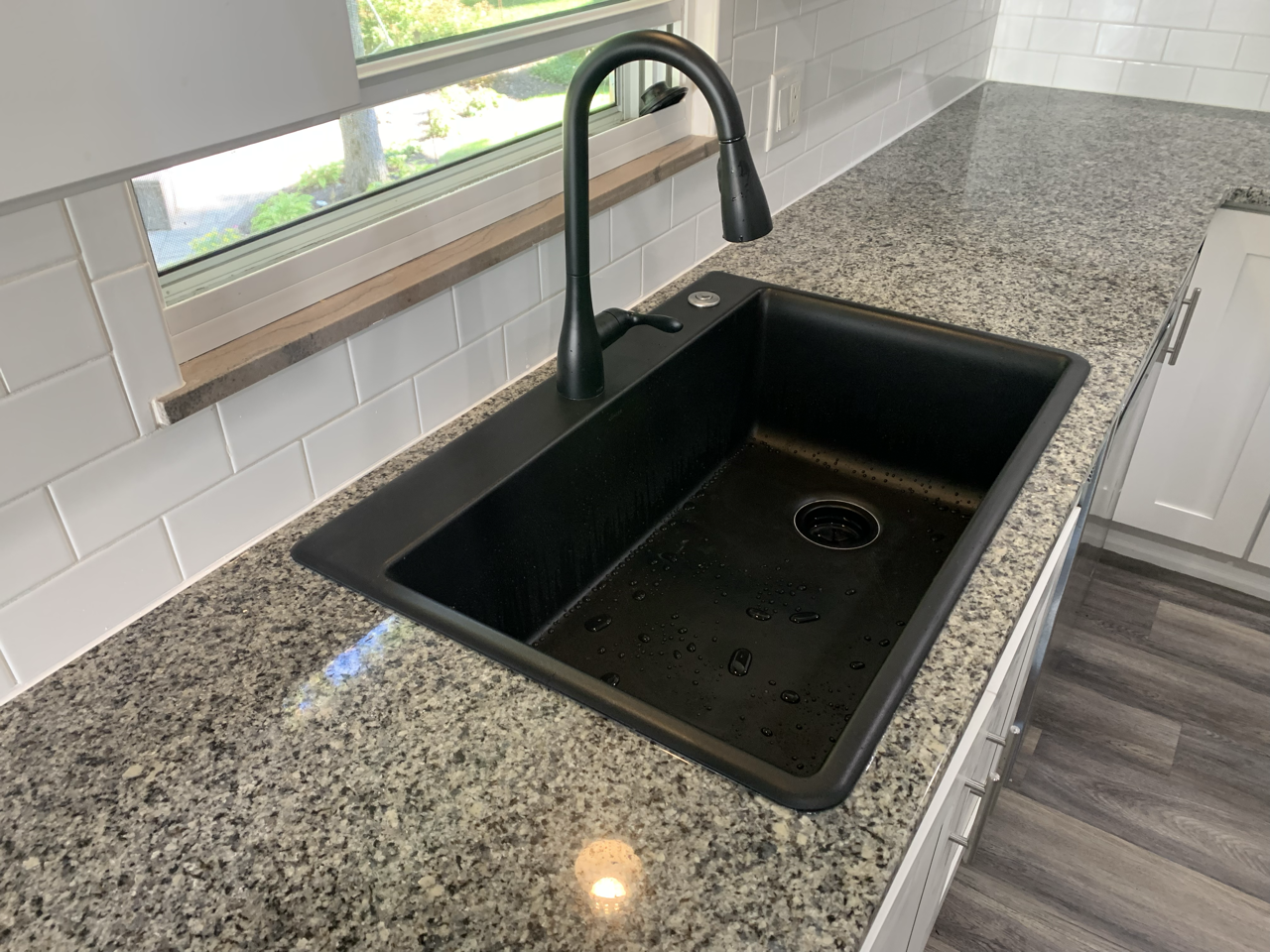 Sleek Black Sink in Granite Countertop after expert replacement by Mr.Countertops