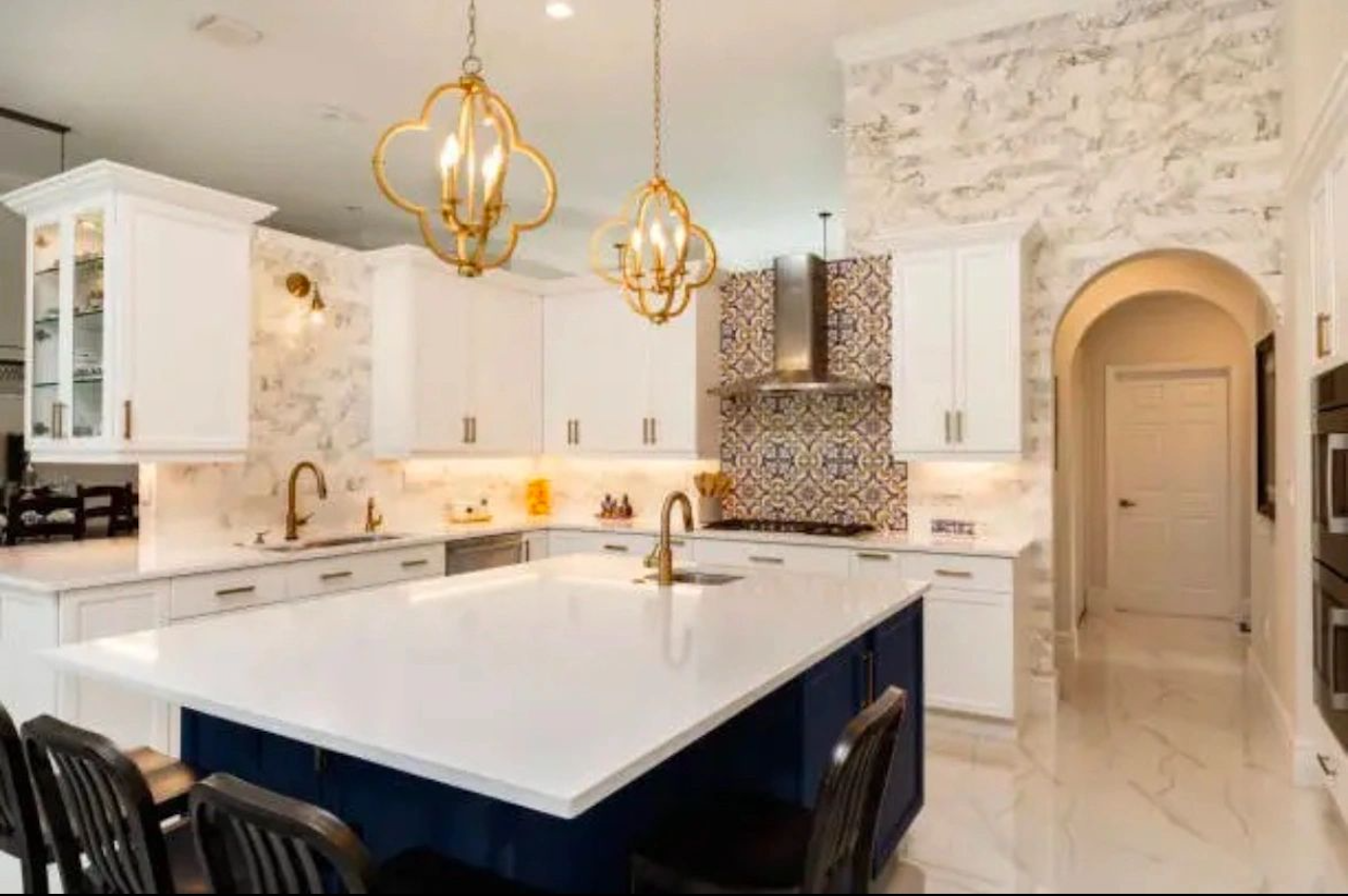 Kitchen Remodel with Navy island and custom white solid surface countertops