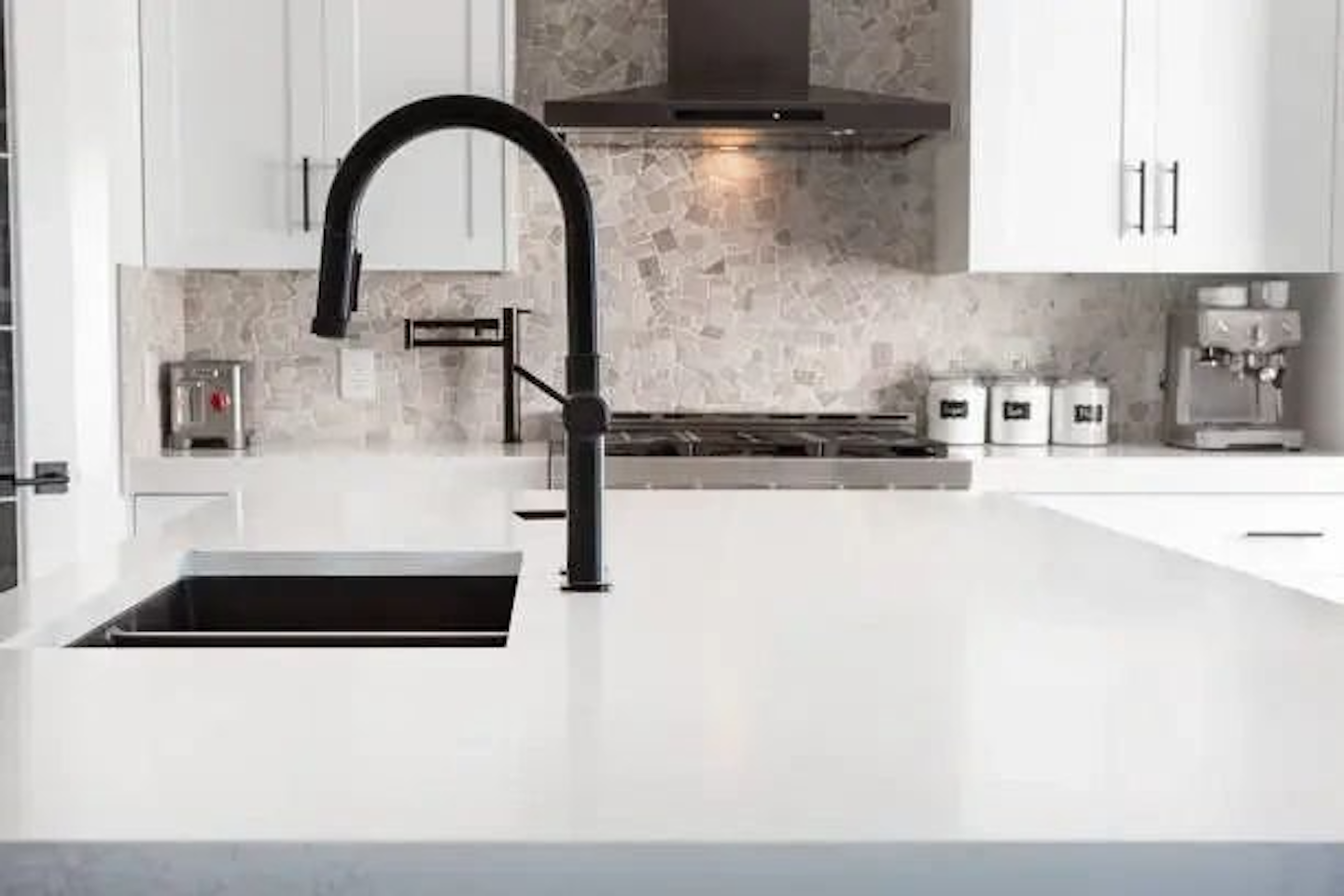 Custom Solid Surface Countertops with undermount sink, modern faucet and plumbing services.