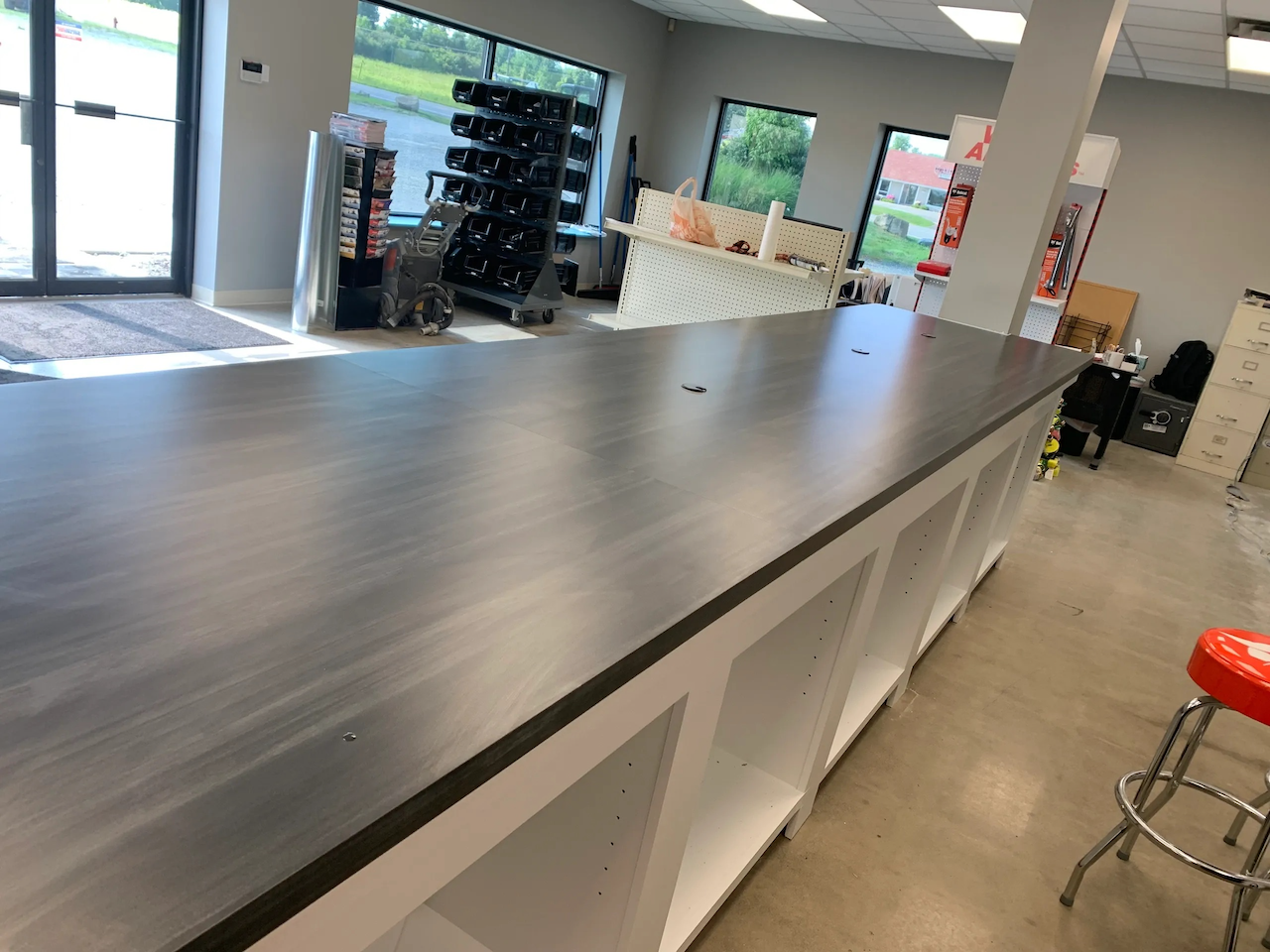 Black Formica retail sales counter custom-built in Medina Ohio for a high-traffic point-of-sale environment.