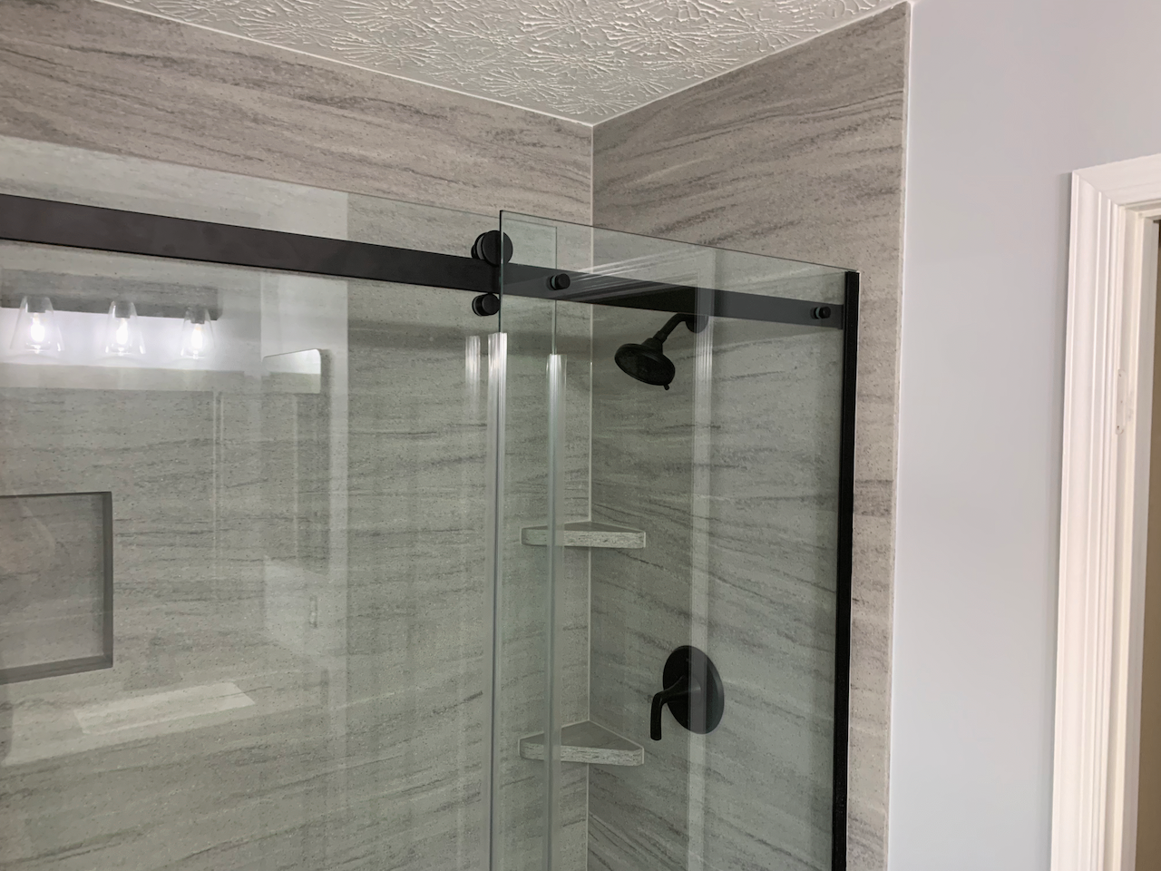 Modern Bathroom Remodel with Custom Acrylic Solid Surface Shower Panels and Glass Shower Door installation. 