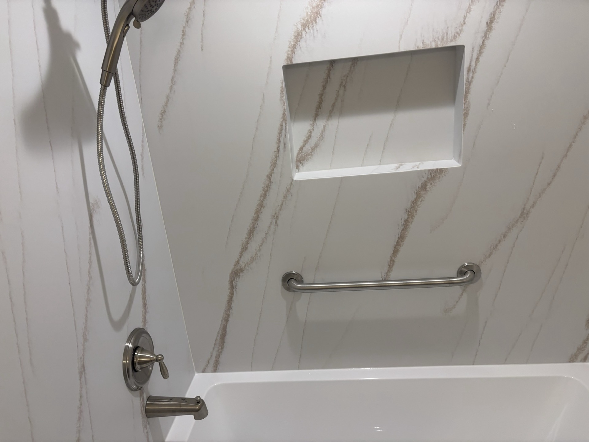 Custom shower with recessed storage, grab bar and lighting in Parma OH