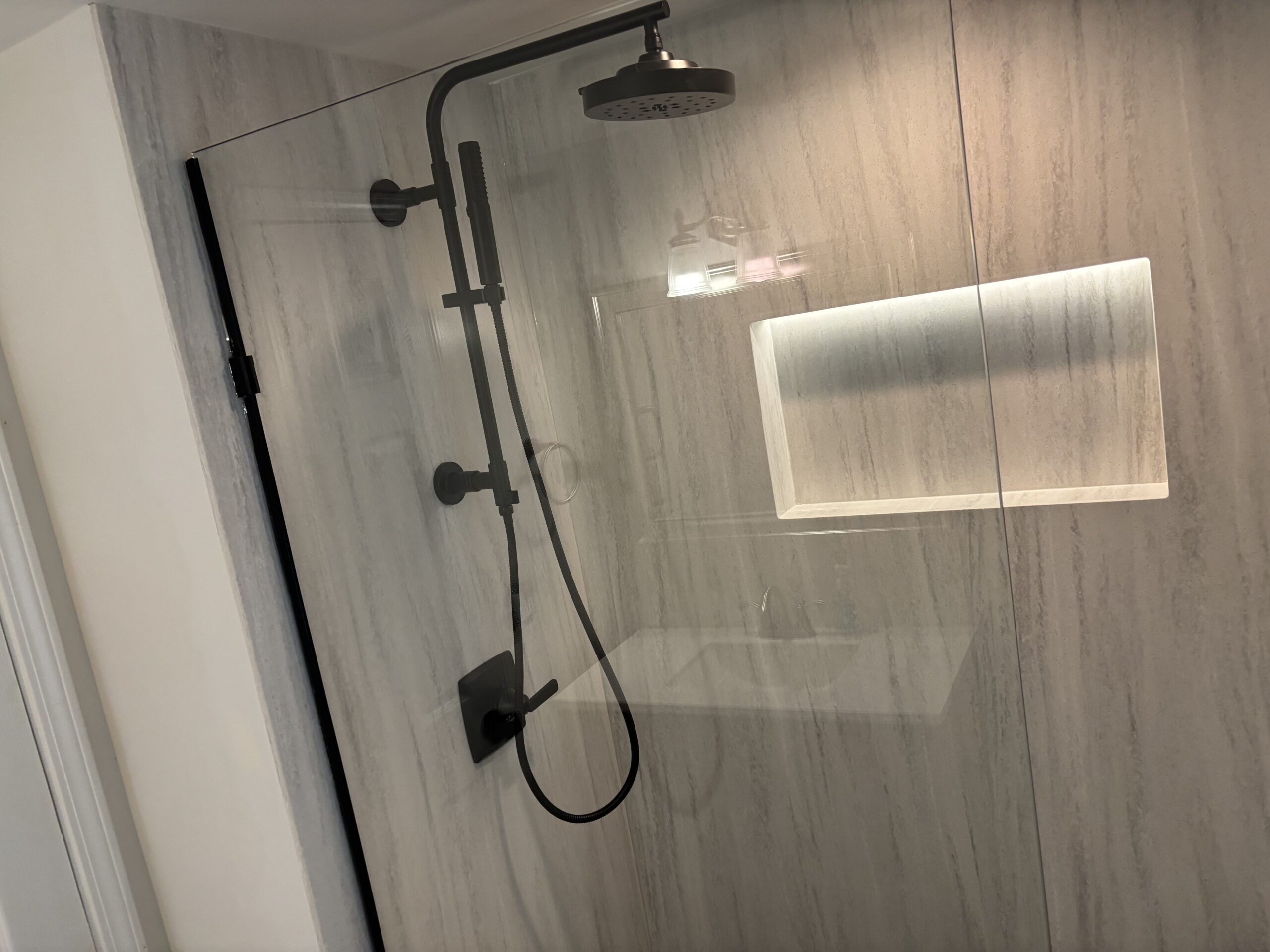 Seamless Custom Shower with glass shower doors in full bathroom remodel by Mr.Countertops